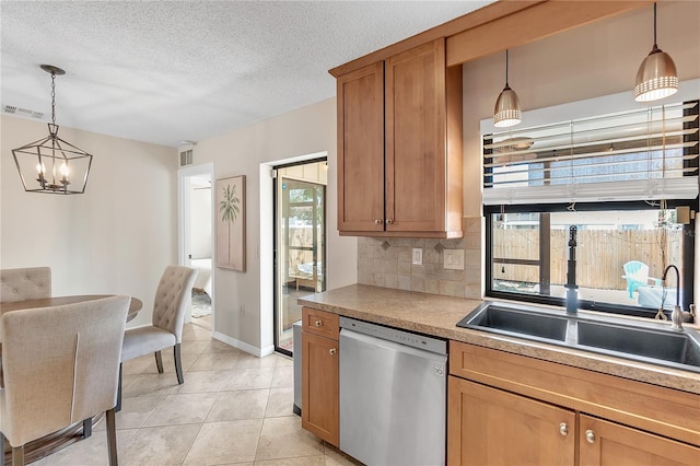 kitchen featuring decorative light fixtures, decorative backsplash, light tile patterned floors, stainless steel dishwasher, and a textured ceiling