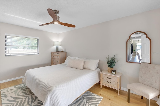 bedroom featuring ceiling fan and light hardwood / wood-style floors