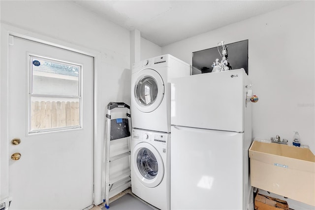 washroom featuring sink and stacked washing maching and dryer