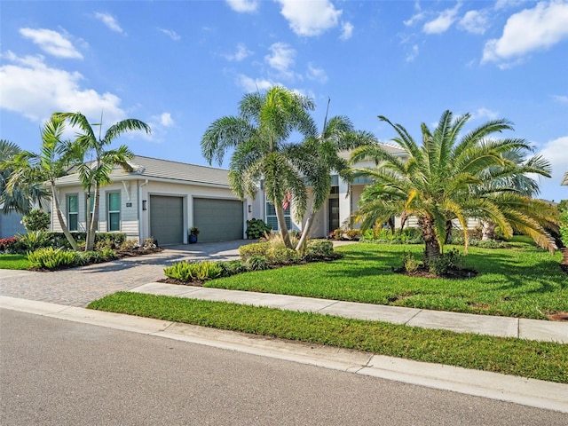 view of front of home featuring a garage and a front lawn