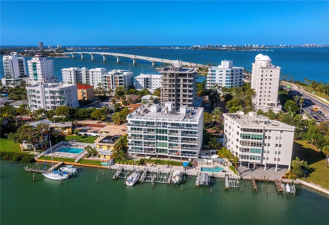 birds eye view of property with a city view and a water view