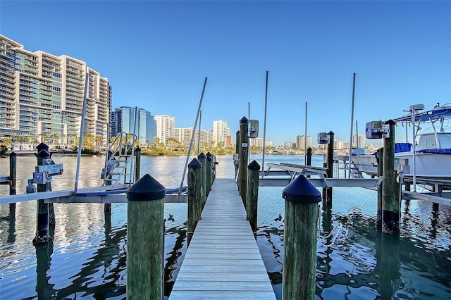 dock area with a city view, a water view, and boat lift