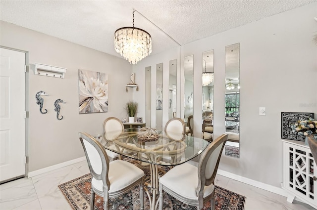 dining space featuring a notable chandelier and a textured ceiling