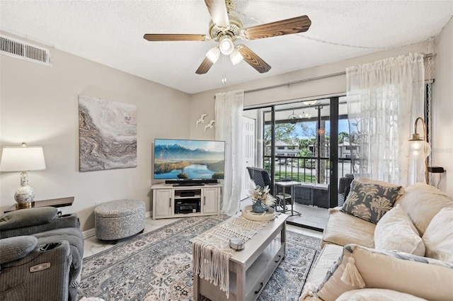 1515 Forrest Nelson Blvd Unit Q205, Port Charlotte, FL 33952 - living area with a textured ceiling, visible vents, tile patterned flooring, and a ceiling fan