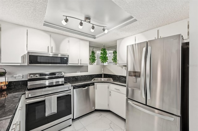 1515 Forrest Nelson Blvd Unit Q205, Port Charlotte, FL 33952 - kitchen featuring a raised ceiling, a sink, stainless steel appliances, and a textured ceiling