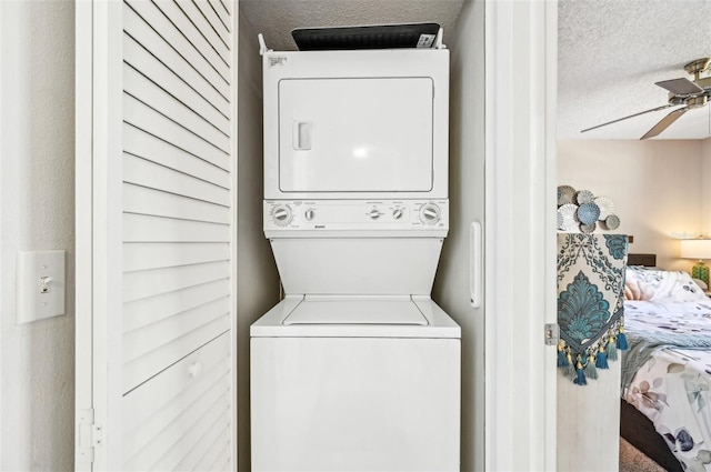 1515 Forrest Nelson Blvd Unit Q205, Port Charlotte, FL 33952 - washroom featuring stacked washer and dryer, a textured ceiling, laundry area, and a ceiling fan