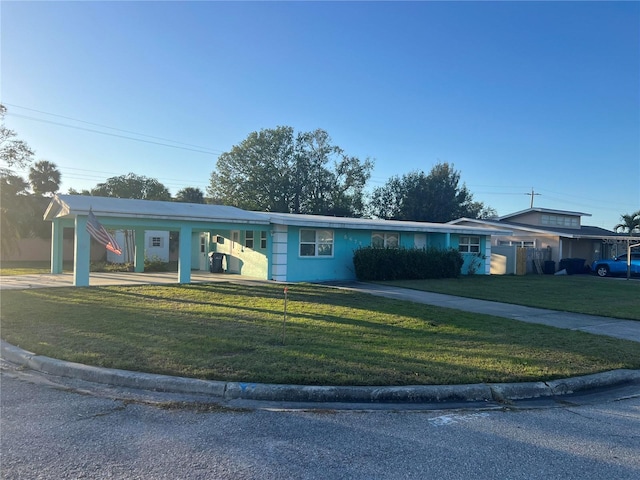 single story home featuring a front yard and a carport