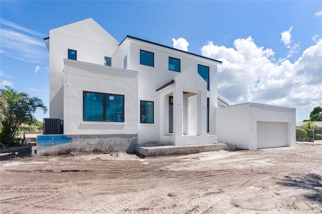 modern home with a garage and central AC unit