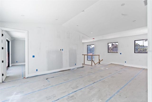 spare room with plenty of natural light and vaulted ceiling