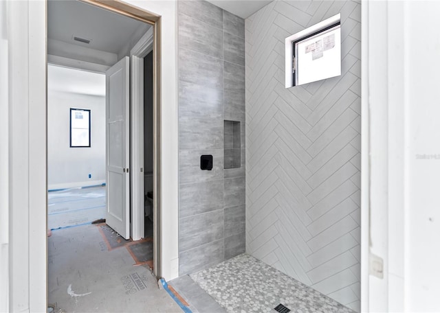 bathroom with tiled shower