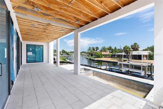 view of patio / terrace featuring a water view and a dock