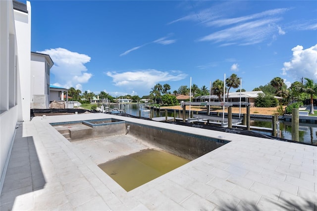 view of pool with a water view and a dock