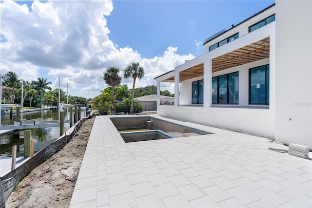 view of patio / terrace with a dock and a water view