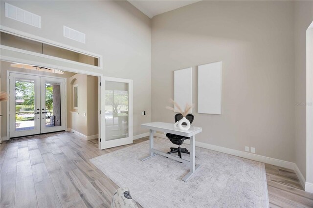 1314 Brambling Ct, Bradenton, FL 34212 - office featuring french doors, healthy amount of natural light, light wood-style floors, a towering ceiling, and baseboards