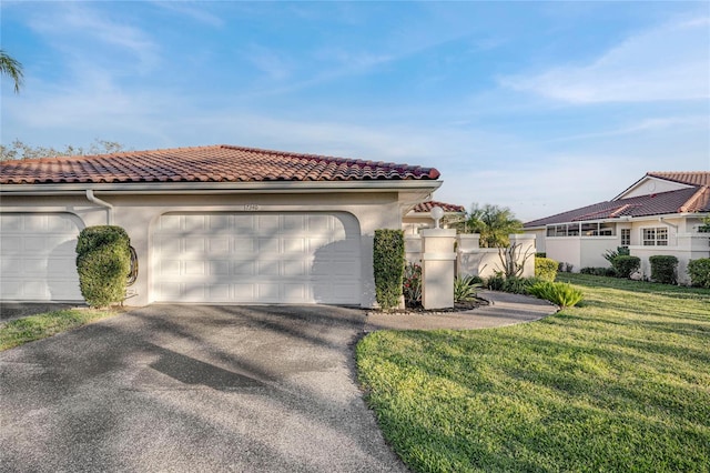 mediterranean / spanish-style house featuring a garage, a tiled roof, a front yard, and stucco siding