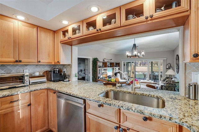 kitchen with tasteful backsplash, a toaster, a sink, and stainless steel dishwasher