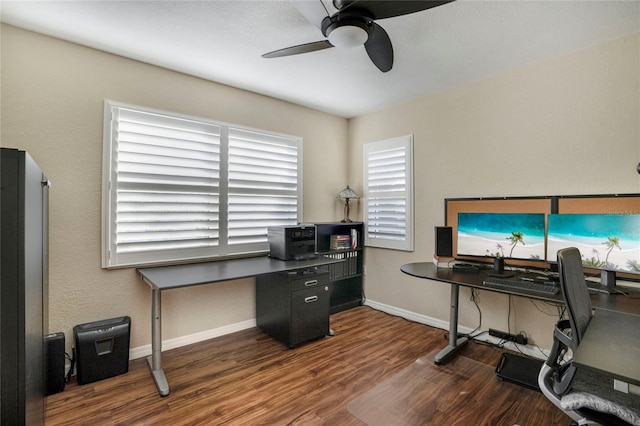 office space with ceiling fan, plenty of natural light, wood finished floors, and baseboards