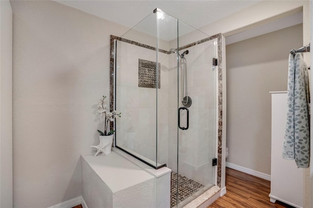 7340 Golf Pointe Cir, Sarasota, FL 34243 - bathroom featuring a shower stall, wood finished floors, and baseboards