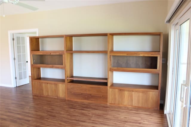 7340 Golf Pointe Cir, Sarasota, FL 34243 - empty room with wood finished floors, a ceiling fan, and baseboards