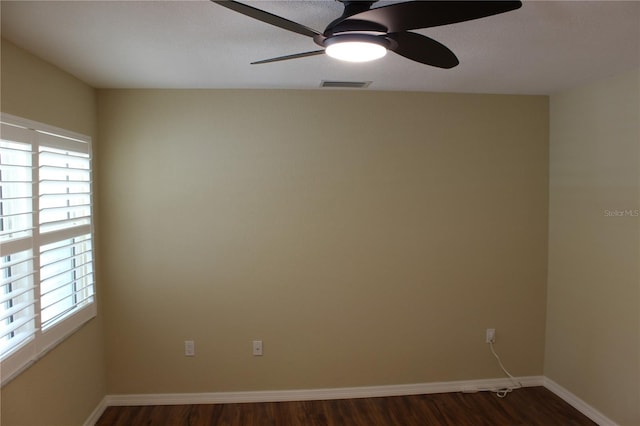 7340 Golf Pointe Cir, Sarasota, FL 34243 - empty room with dark wood finished floors, ceiling fan, plenty of natural light, and baseboards