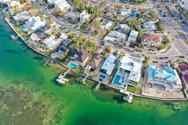 drone / aerial view with a water view and a residential view