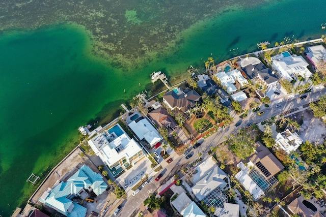 drone / aerial view with a residential view and a water view