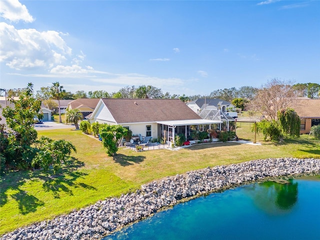 back of house with a water view, a lanai, a patio area, and a lawn