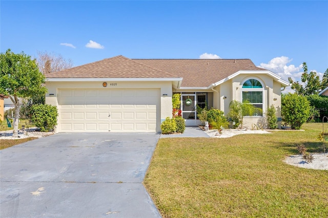 ranch-style house with a garage and a front lawn