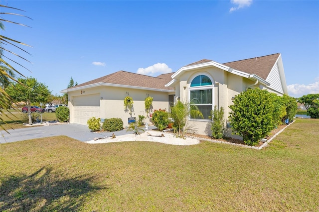 view of front of property with a garage and a front lawn