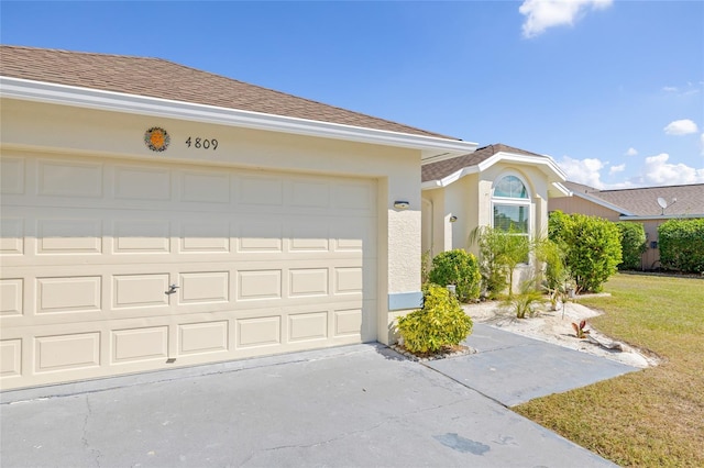 view of front of home featuring a garage and a front lawn