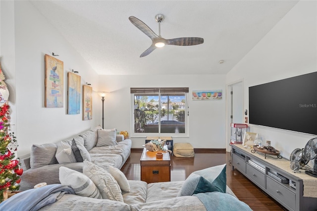 living room featuring lofted ceiling, dark wood-type flooring, and ceiling fan