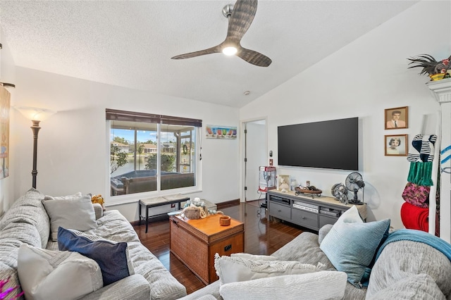 living room featuring lofted ceiling, a textured ceiling, dark hardwood / wood-style floors, and ceiling fan