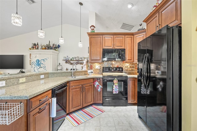 kitchen with lofted ceiling, sink, light stone counters, decorative light fixtures, and black appliances