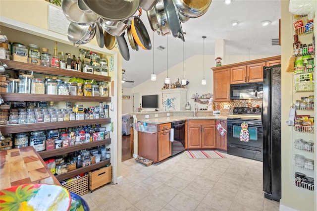 kitchen featuring sink, decorative light fixtures, black appliances, vaulted ceiling, and backsplash