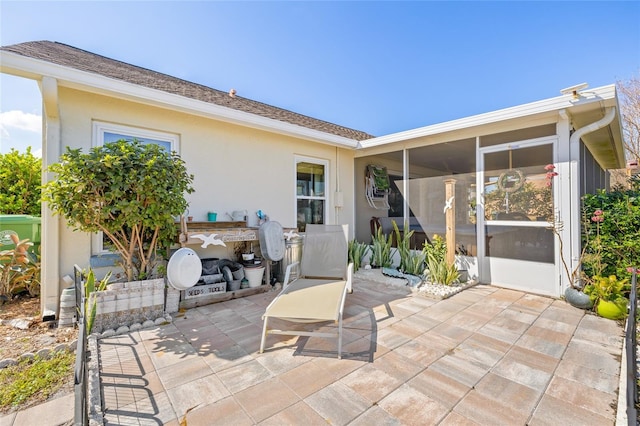 view of patio featuring a sunroom