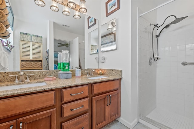 bathroom featuring vanity, a tile shower, and ceiling fan