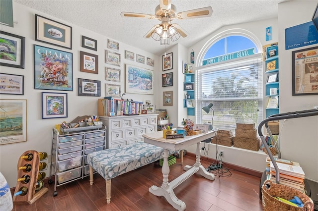 living area with ceiling fan, hardwood / wood-style floors, and a textured ceiling