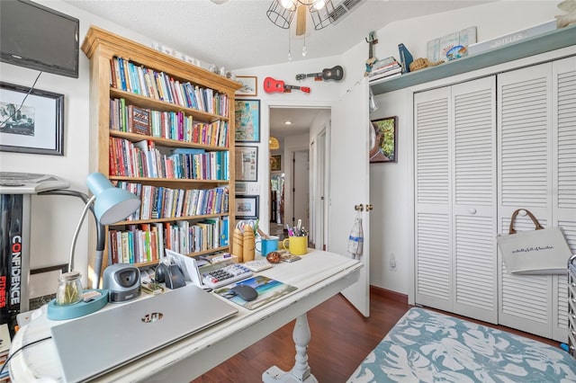 home office featuring dark hardwood / wood-style floors and a textured ceiling