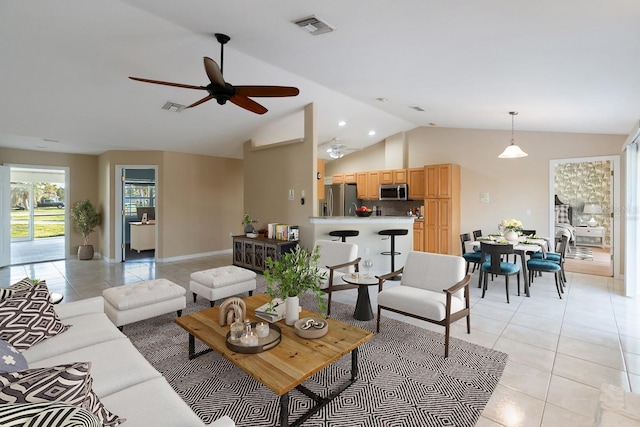 living room with light tile patterned flooring, vaulted ceiling, and ceiling fan