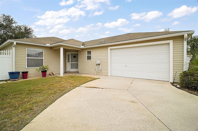 single story home featuring a garage and a front yard