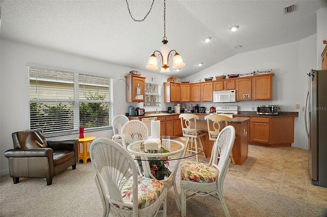 dining area with light tile patterned floors, sink, a notable chandelier, a textured ceiling, and vaulted ceiling