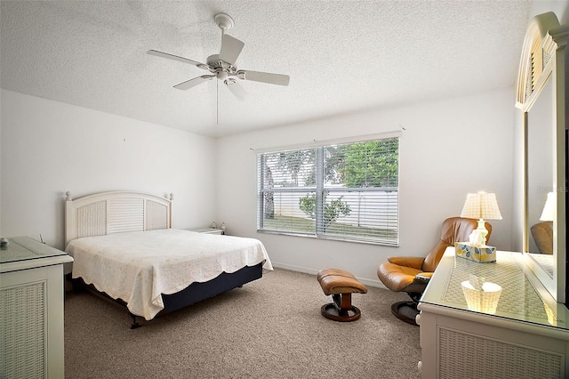 bedroom featuring ceiling fan, carpet flooring, and a textured ceiling