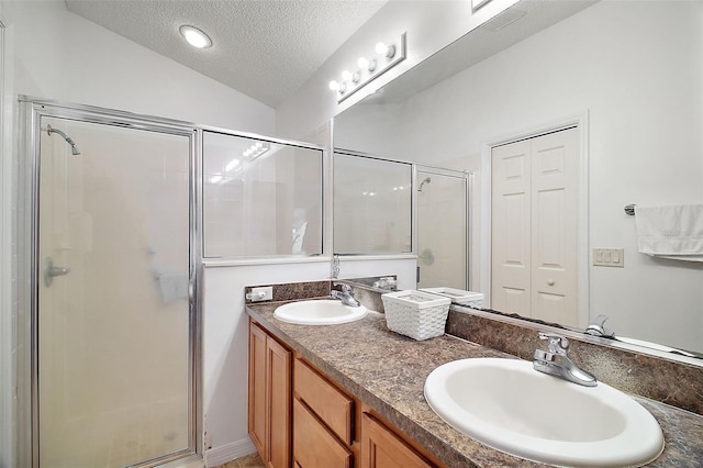 bathroom featuring lofted ceiling, vanity, a textured ceiling, and walk in shower