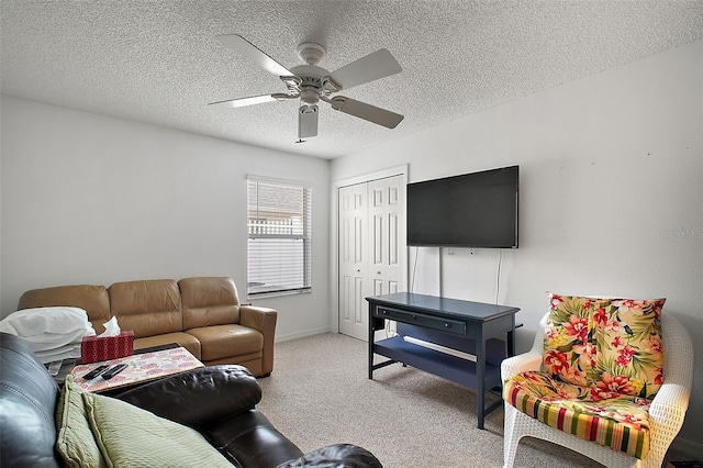 carpeted living room featuring a textured ceiling and ceiling fan