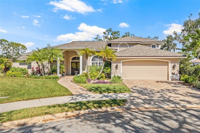 view of front of home featuring a garage and a front lawn