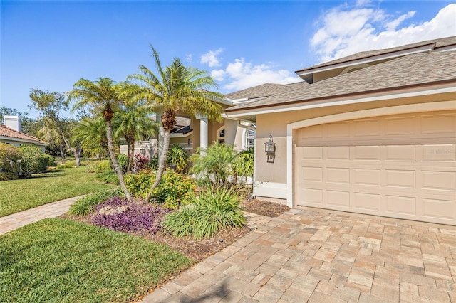 view of front of home featuring a garage and a front lawn