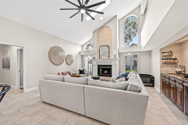 living room with high vaulted ceiling, sink, and ceiling fan