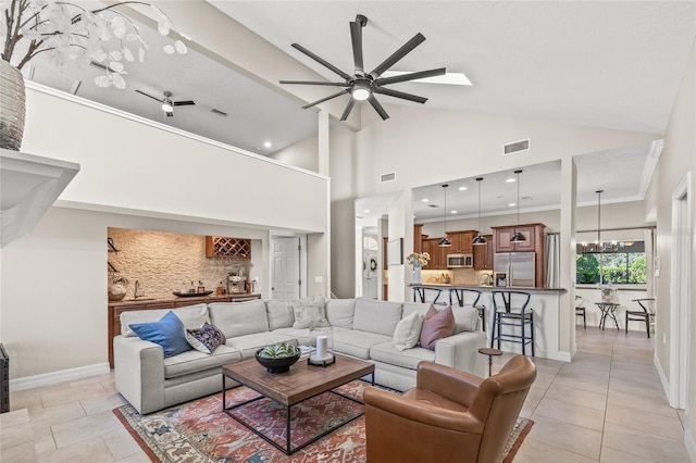 living room with light tile patterned flooring, high vaulted ceiling, and ceiling fan with notable chandelier