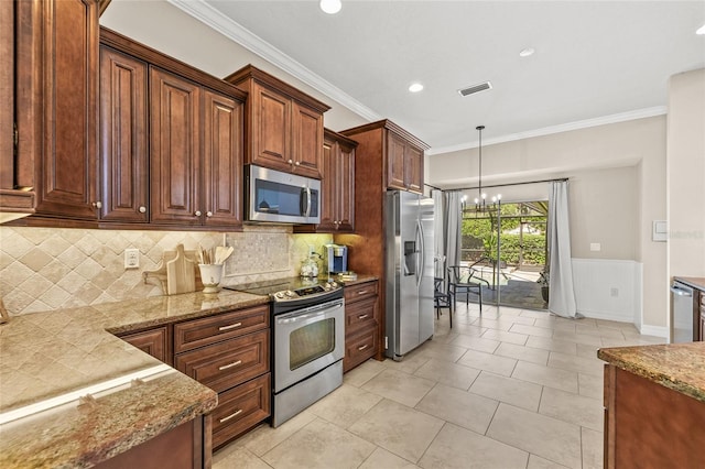 kitchen featuring a notable chandelier, decorative light fixtures, ornamental molding, and appliances with stainless steel finishes