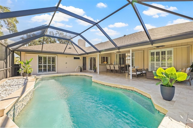 view of pool with a lanai, a patio area, and ceiling fan